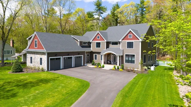 a front view of a house with a yard table and chairs