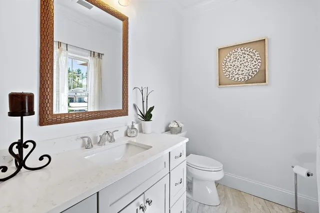 a bathroom with a toilet a sink and a mirror