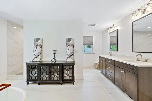 a bathroom with a sink a mirror and a bathtub