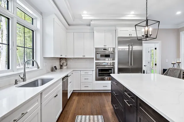 a kitchen with stainless steel appliances a sink stove and refrigerator