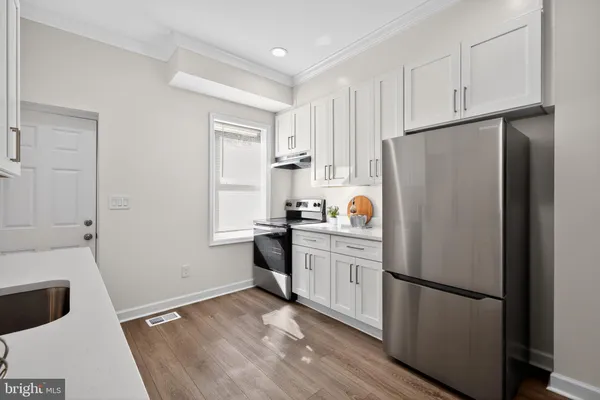 a white refrigerator freezer sitting in a kitchen