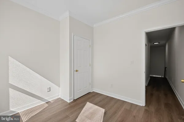 a view of hallway with wooden floor