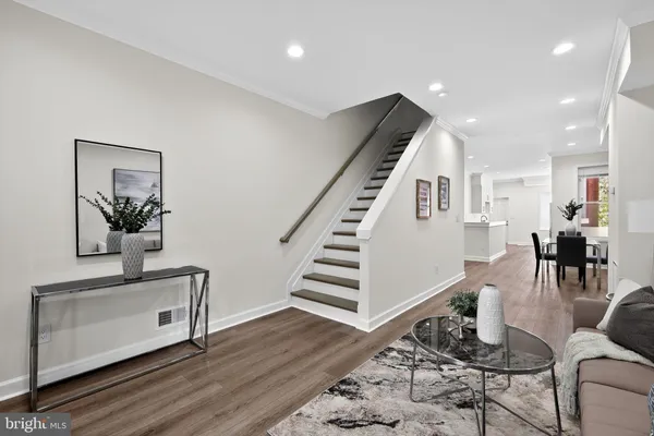 a living room with furniture and wooden floor