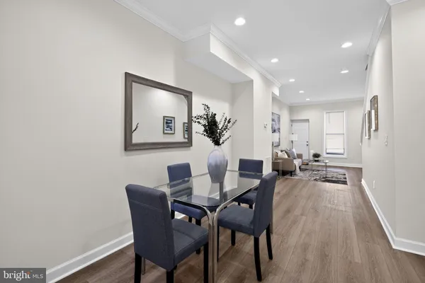 a view of a dining room with furniture and wooden floor