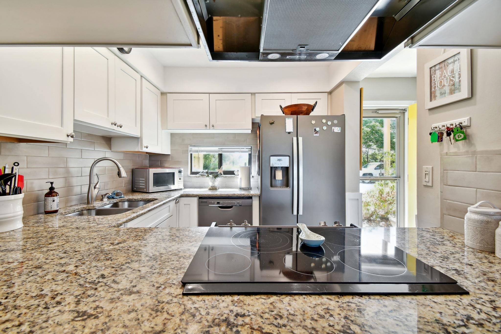 131 Rio Del Mar Street, Unit E St. Augustine, FL 32080 - Photo 16 of 67 a kitchen with stainless steel appliances granite countertop a sink stove and refrigerator