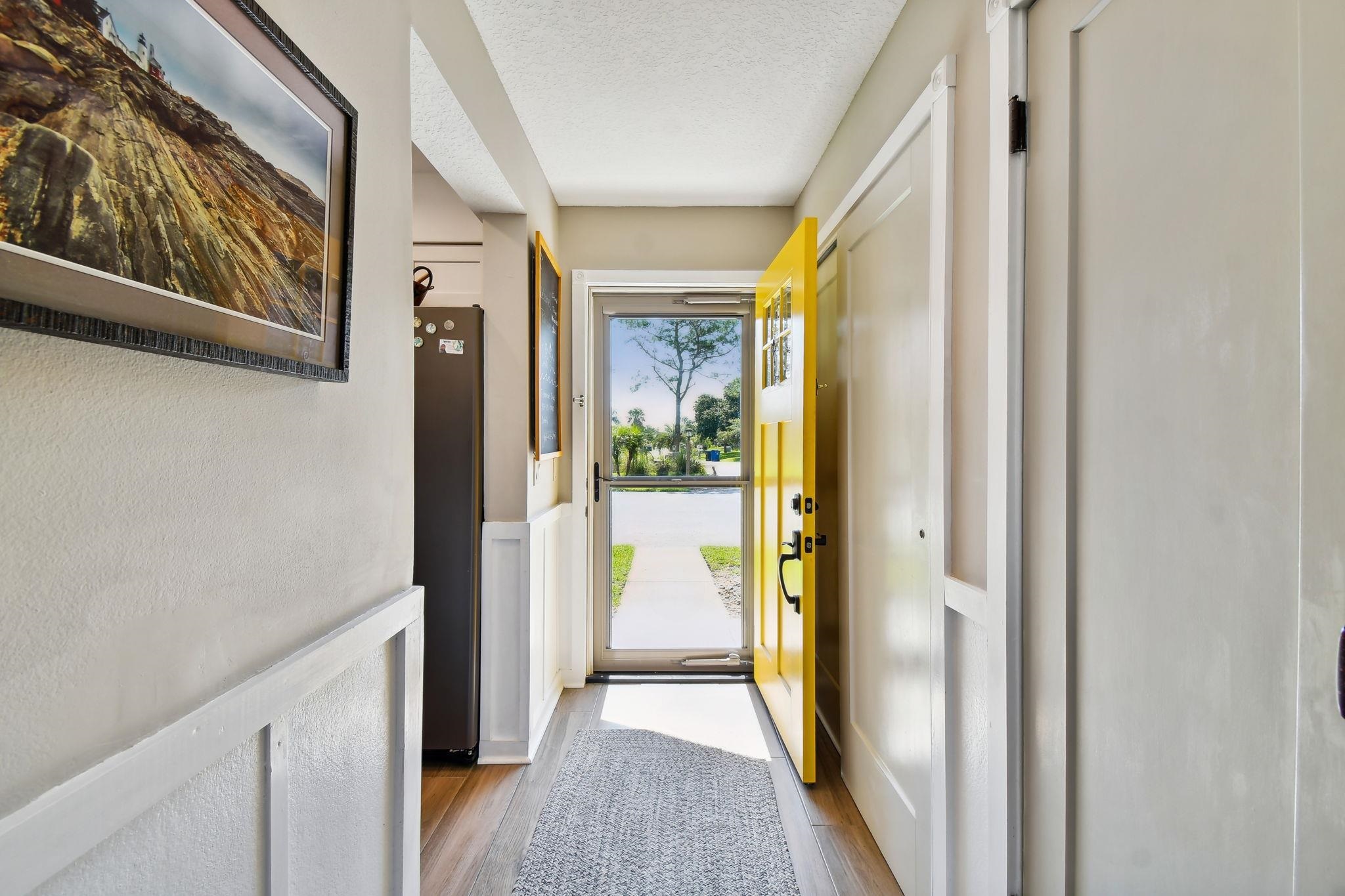 131 Rio Del Mar Street, Unit E St. Augustine, FL 32080 - Photo 20 of 67 a view of a hallway with wooden floor and windows
