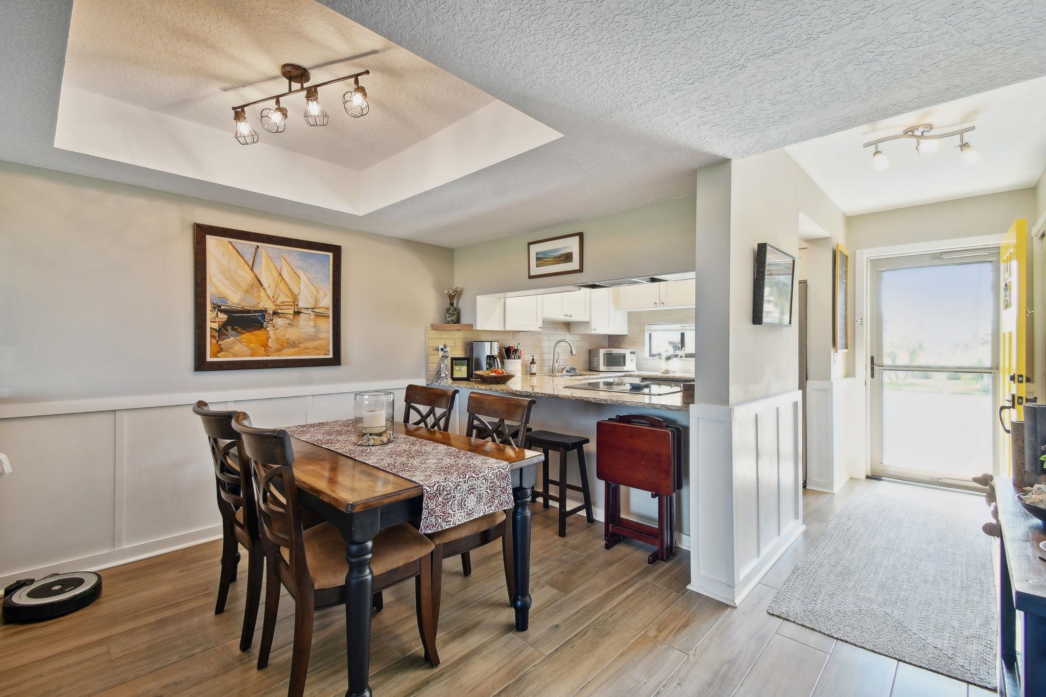 131 Rio Del Mar Street, Unit E St. Augustine, FL 32080 - Photo 23 of 67 a view of a dining room with furniture and wooden floor