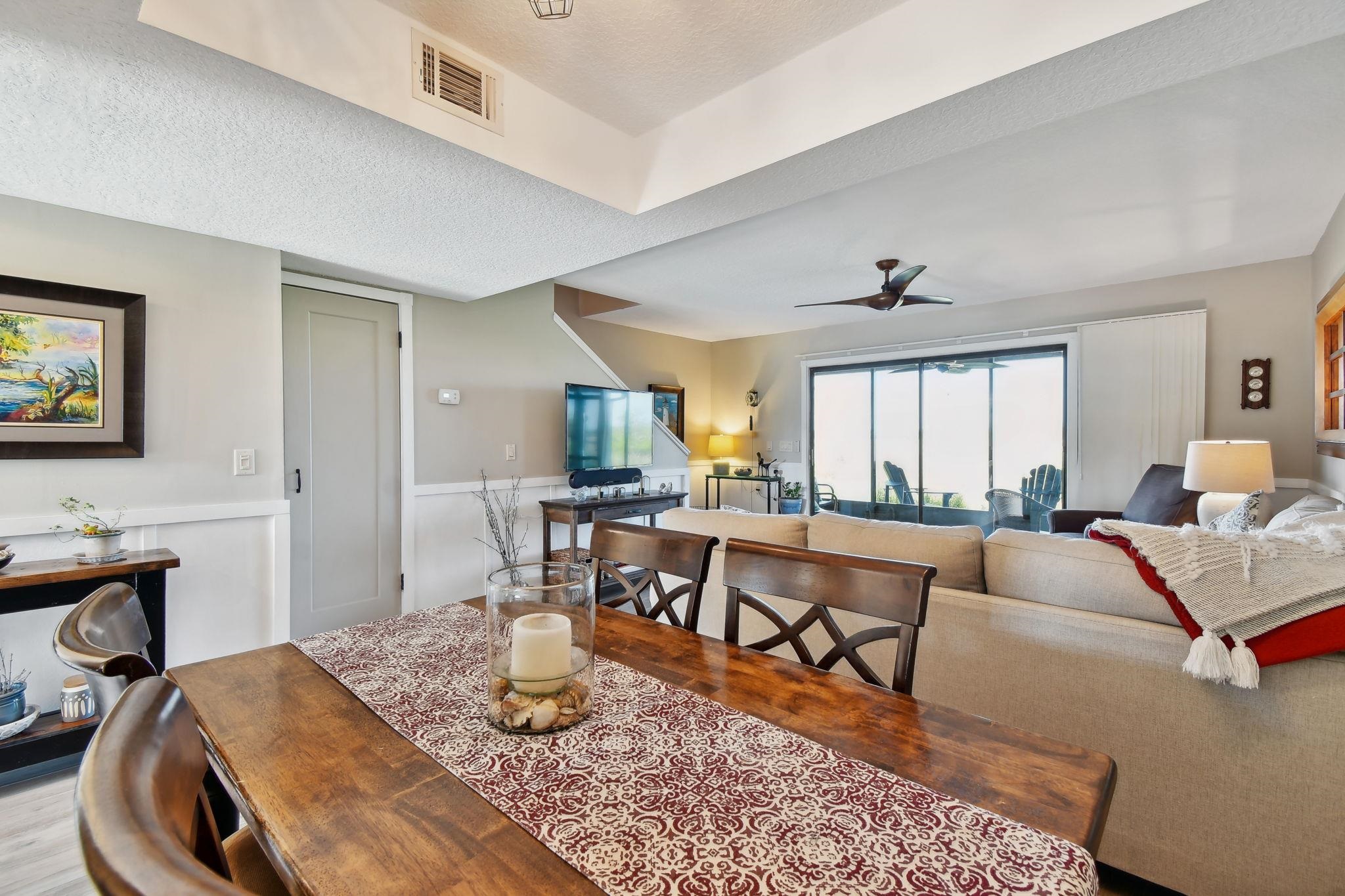 131 Rio Del Mar Street, Unit E St. Augustine, FL 32080 - Photo 24 of 67 a living room with furniture and a wooden floor