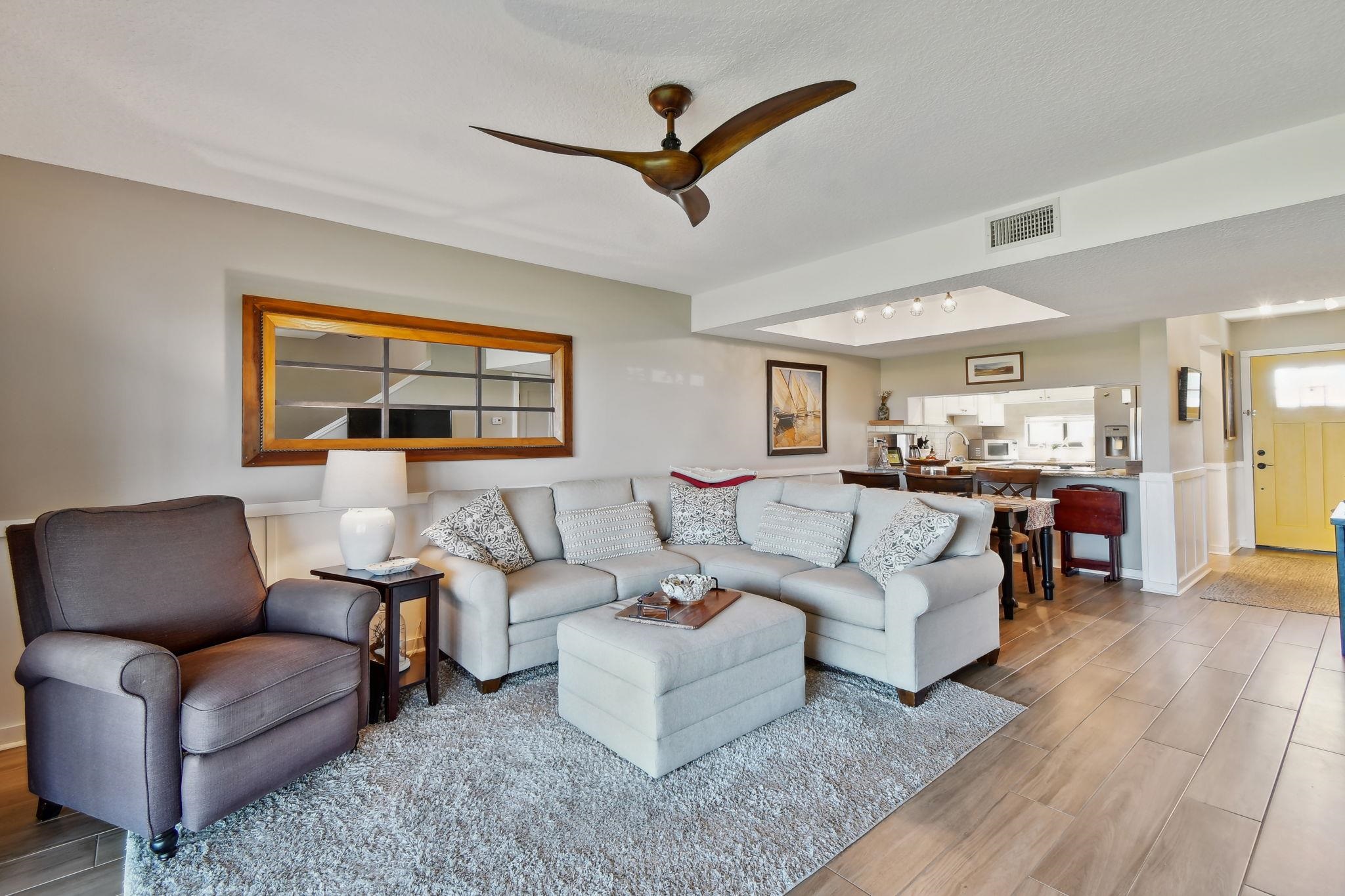 131 Rio Del Mar Street, Unit E St. Augustine, FL 32080 - Photo 28 of 67 a living room with furniture or couch and a ceiling fan