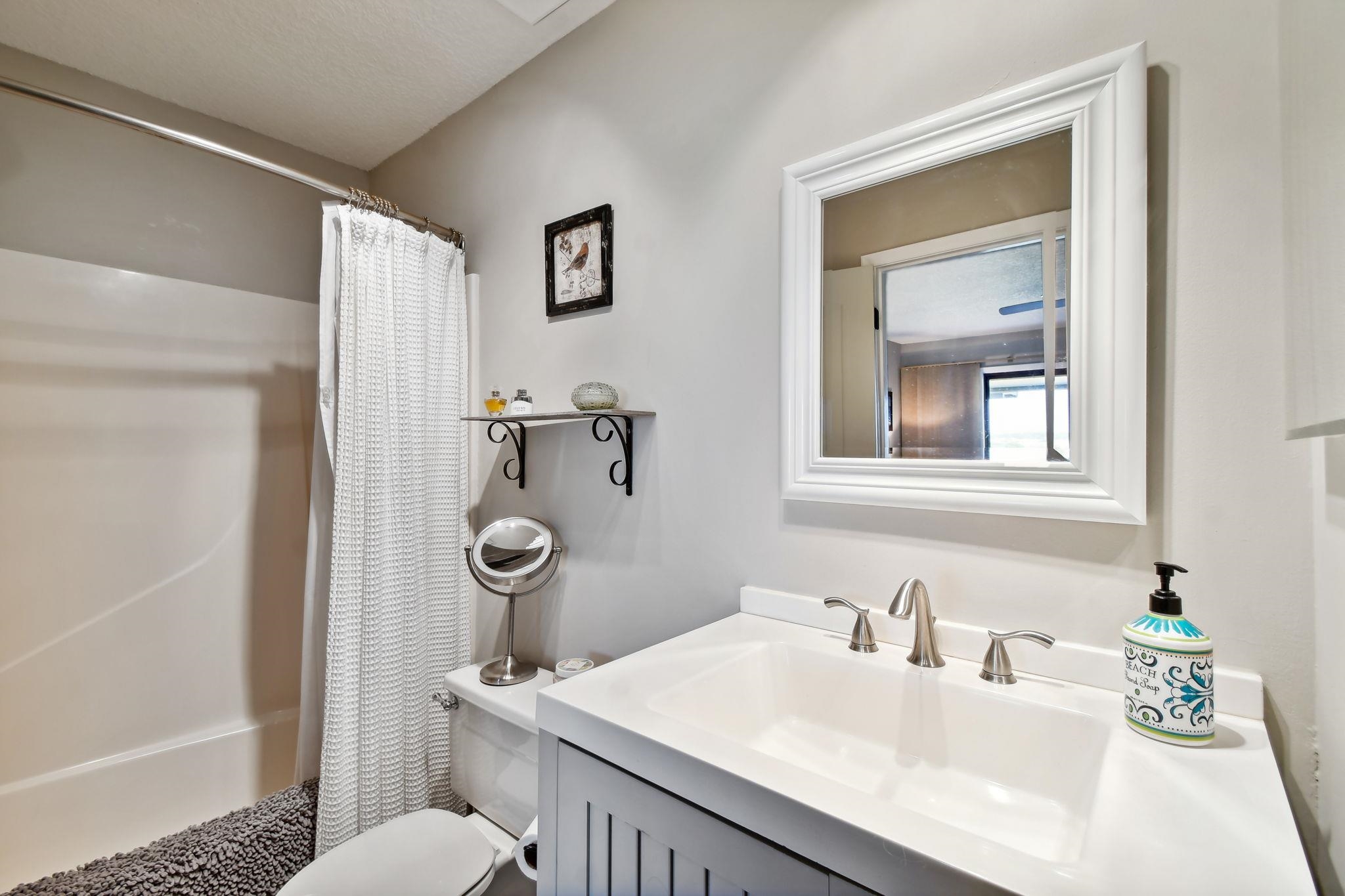 131 Rio Del Mar Street, Unit E St. Augustine, FL 32080 - Photo 33 of 67 a bathroom with a sink a toilet and shower