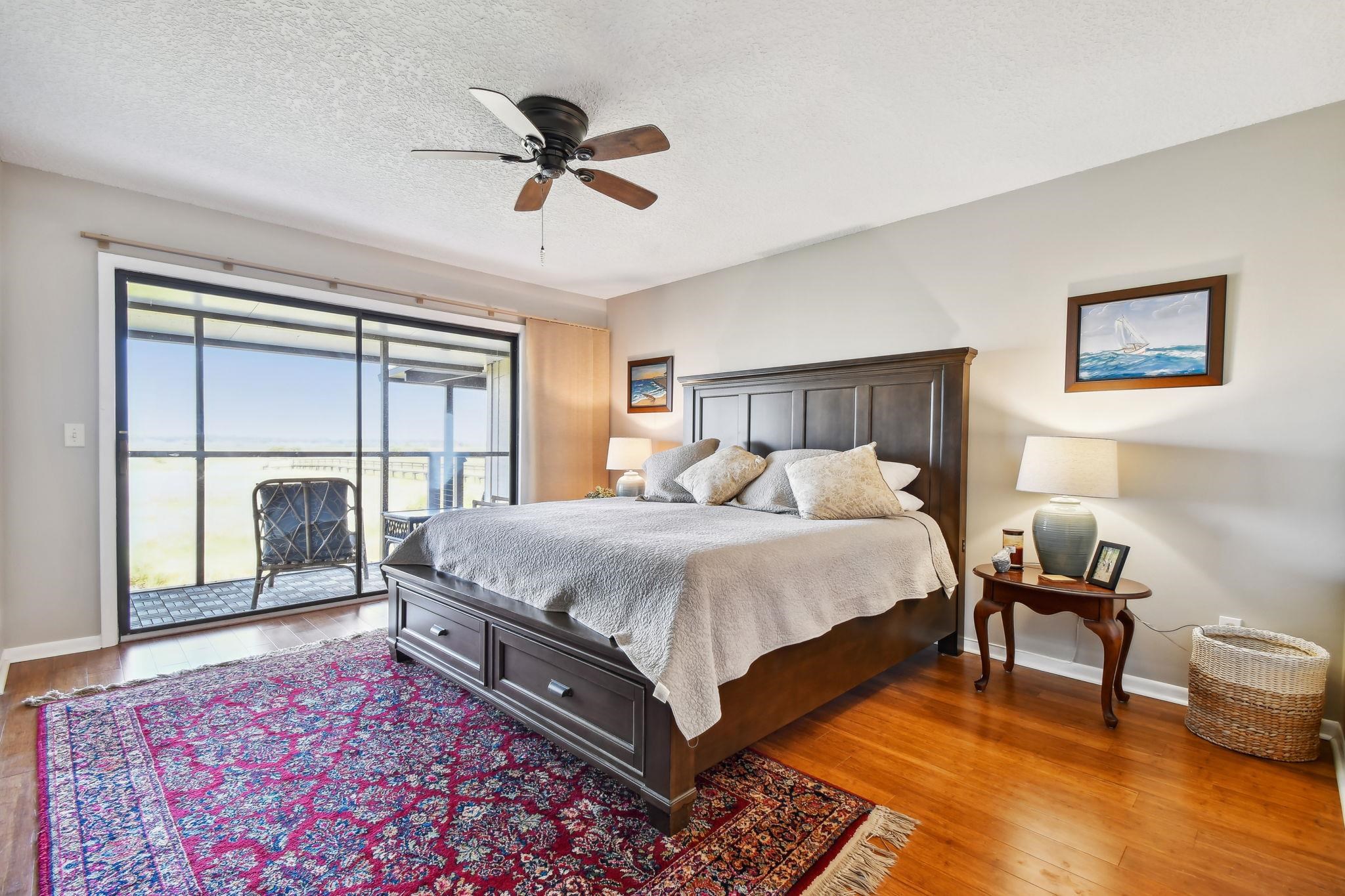 131 Rio Del Mar Street, Unit E St. Augustine, FL 32080 - Photo 38 of 67 a bed sitting in a bedroom next to a window