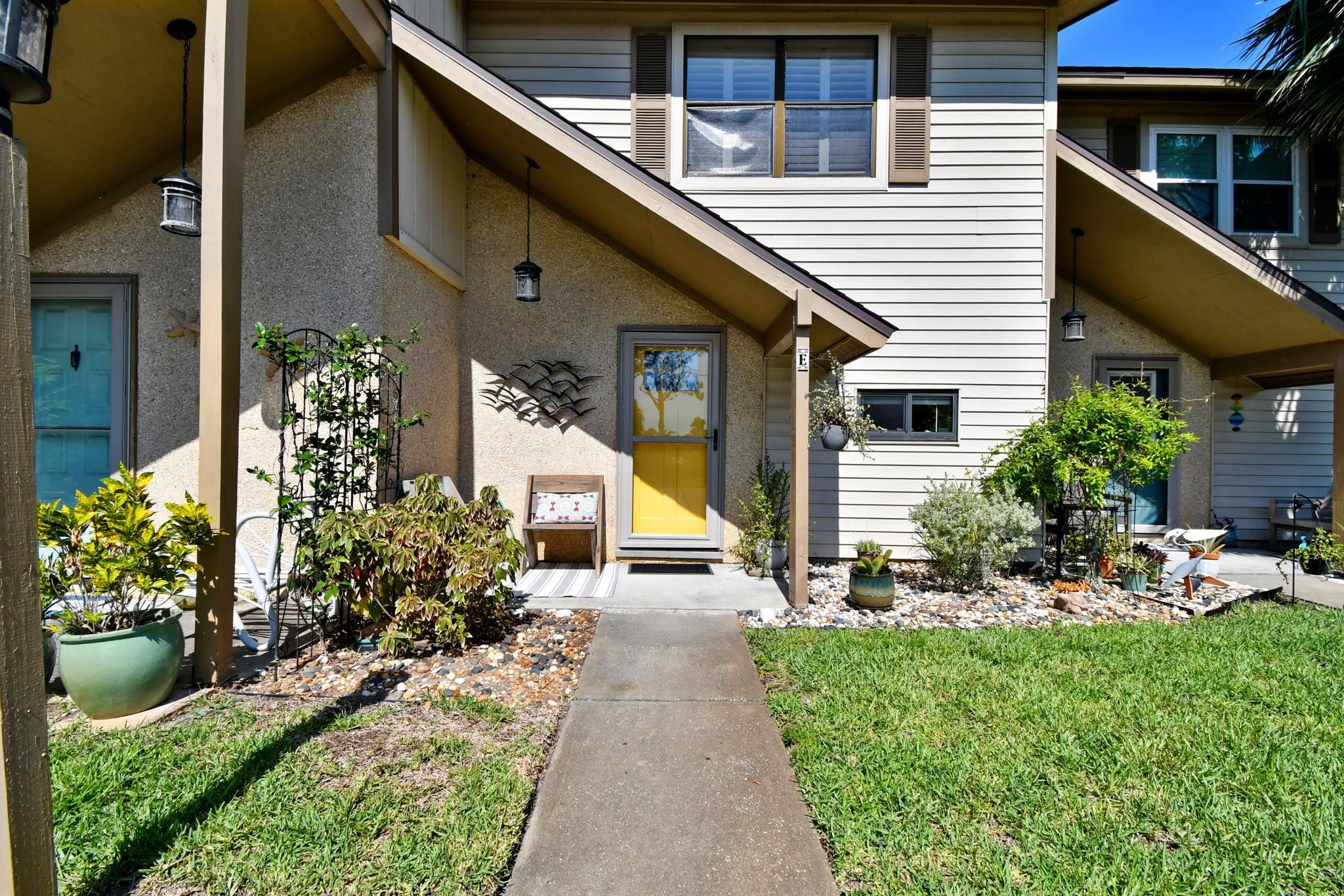 131 Rio Del Mar Street, Unit E St. Augustine, FL 32080 - Photo 6 of 67 a view of a house with sitting area and garden