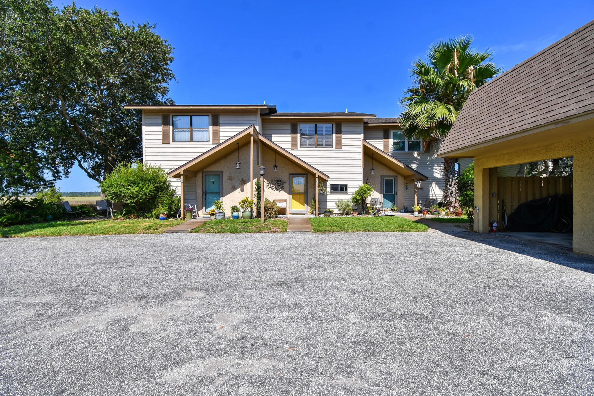131 Rio Del Mar Street, Unit E St. Augustine, FL 32080 - Photo 8 of 67 a front view of a house with a yard and garage