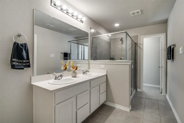 a bathroom with a sink double vanity and a mirror