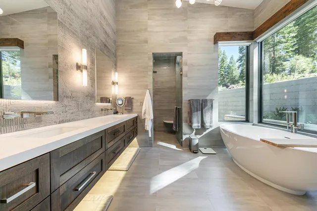 a large bathroom with a large tub and sink