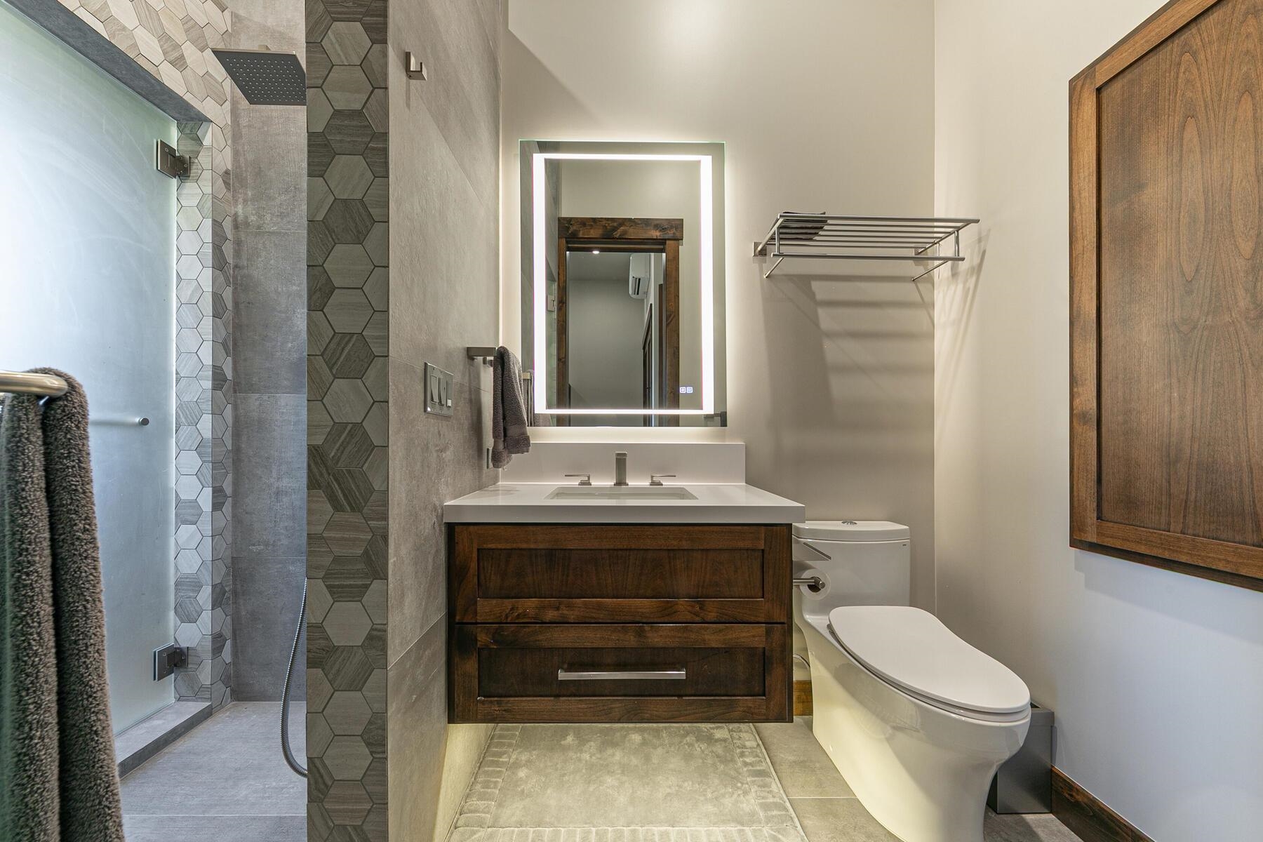 10645 Carson Range Road Truckee, CA 96161 - Photo 24 of 28 a bathroom with a toilet a sink and mirror