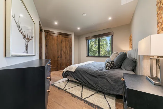 a bedroom with a large bed and a window