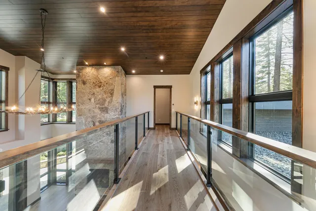 a view of staircase with lots of wooden floor and windows
