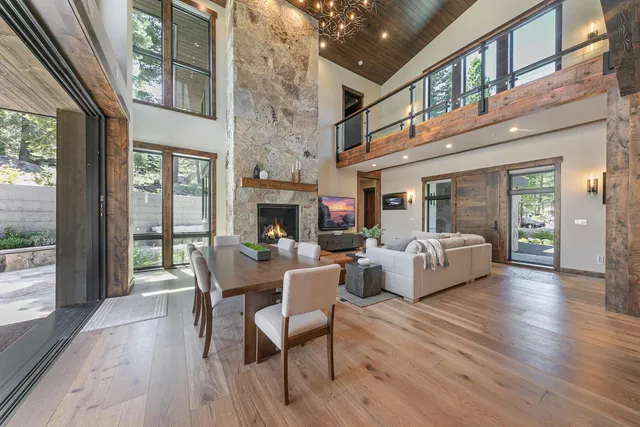 a living room with fireplace furniture and a large window