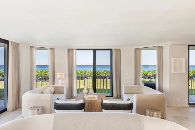 a dining room with furniture a chandelier and wooden floor