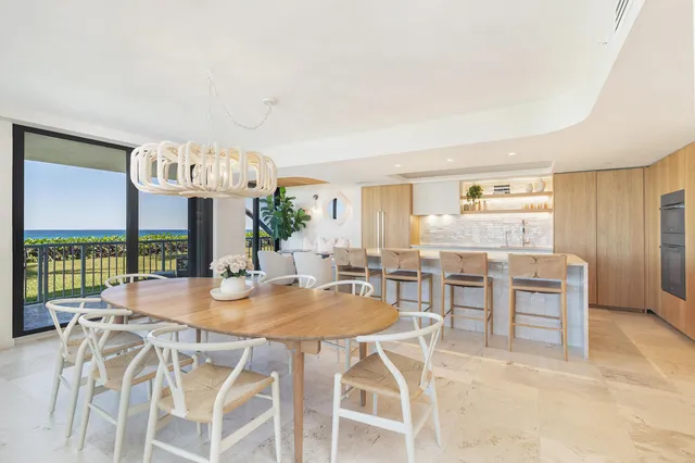 a view of a patio with table and chairs potted plants with wooden floor
