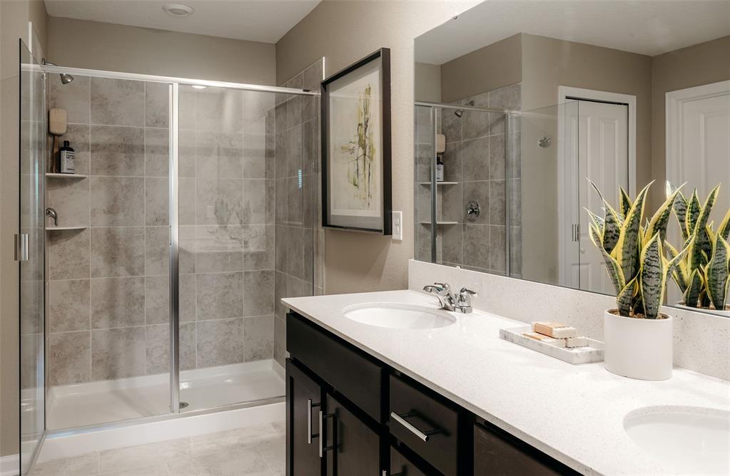 2011 Myrtle Pine Street Kissimmee, FL 34746 - Photo 11 of 28 a bathroom with a granite countertop sink a mirror and a shower