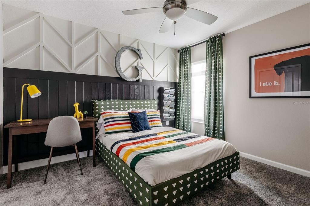 2011 Myrtle Pine Street Kissimmee, FL 34746 - Photo 13 of 28 a bed room with a bed mirror and a window