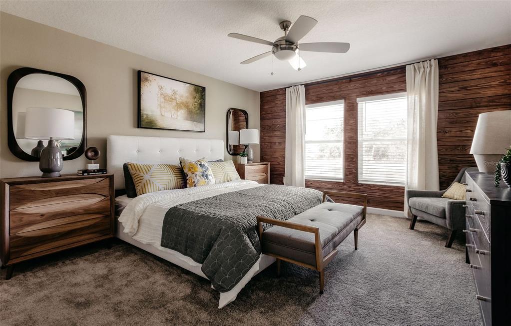 2011 Myrtle Pine Street Kissimmee, FL 34746 - Photo 10 of 28 a spacious bedroom with a bed a dresser next to a window