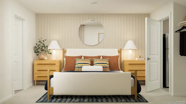 a living room with a couch and a potted plant