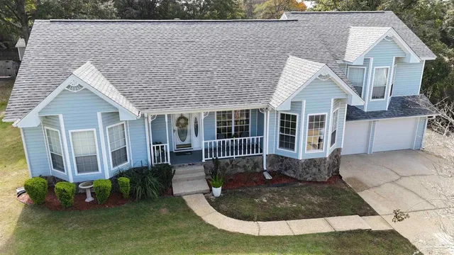 a aerial view of a house with yard