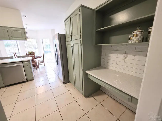 a living room with furniture a fireplace and a large window