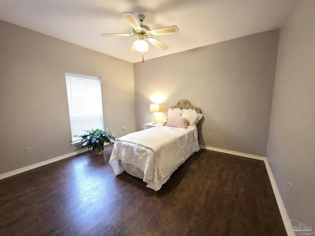 a spacious bedroom with a bed and a chandelier