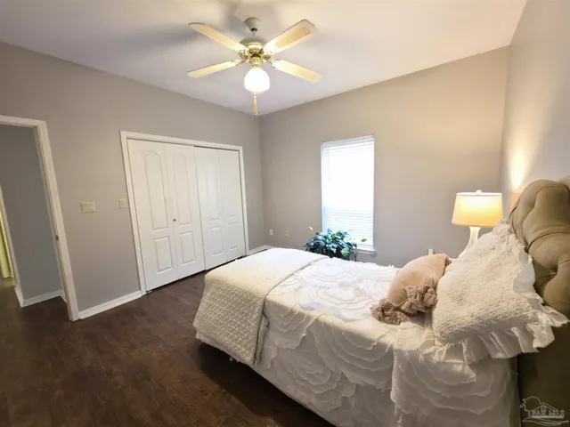 a spacious bedroom with a bed and a flat screen tv