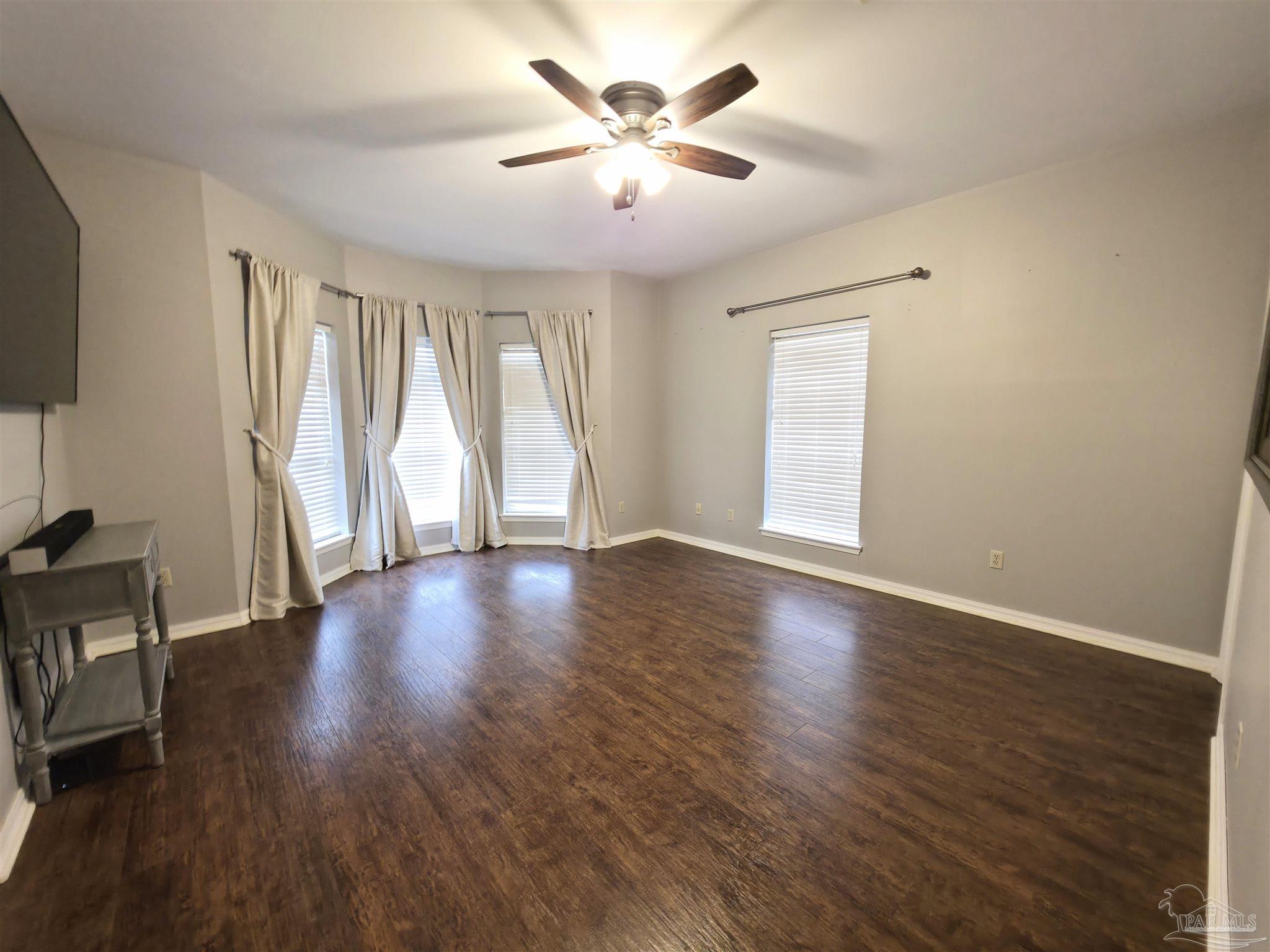 3249 Windmill Circle Cantonment, FL 32533 - Photo 23 of 44 a view of an empty room with wooden floor and a window