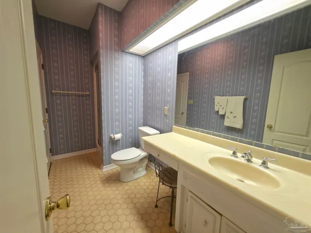 a bathroom with a bathtub sink and mirror