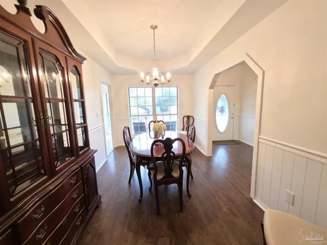a view of a dining room with furniture window and outside view