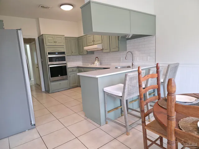 a kitchen with stainless steel appliances a stove sink and cabinets