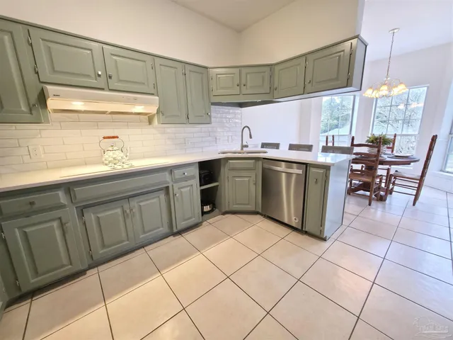a kitchen with stainless steel appliances a refrigerator and a stove