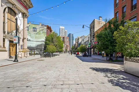 a view of a street with tall buildings