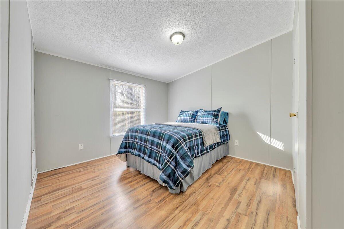 5452 Haw Patch Road Ferrum, VA 24088 - Photo 17 of 35 a bedroom with a bed and wooden floor