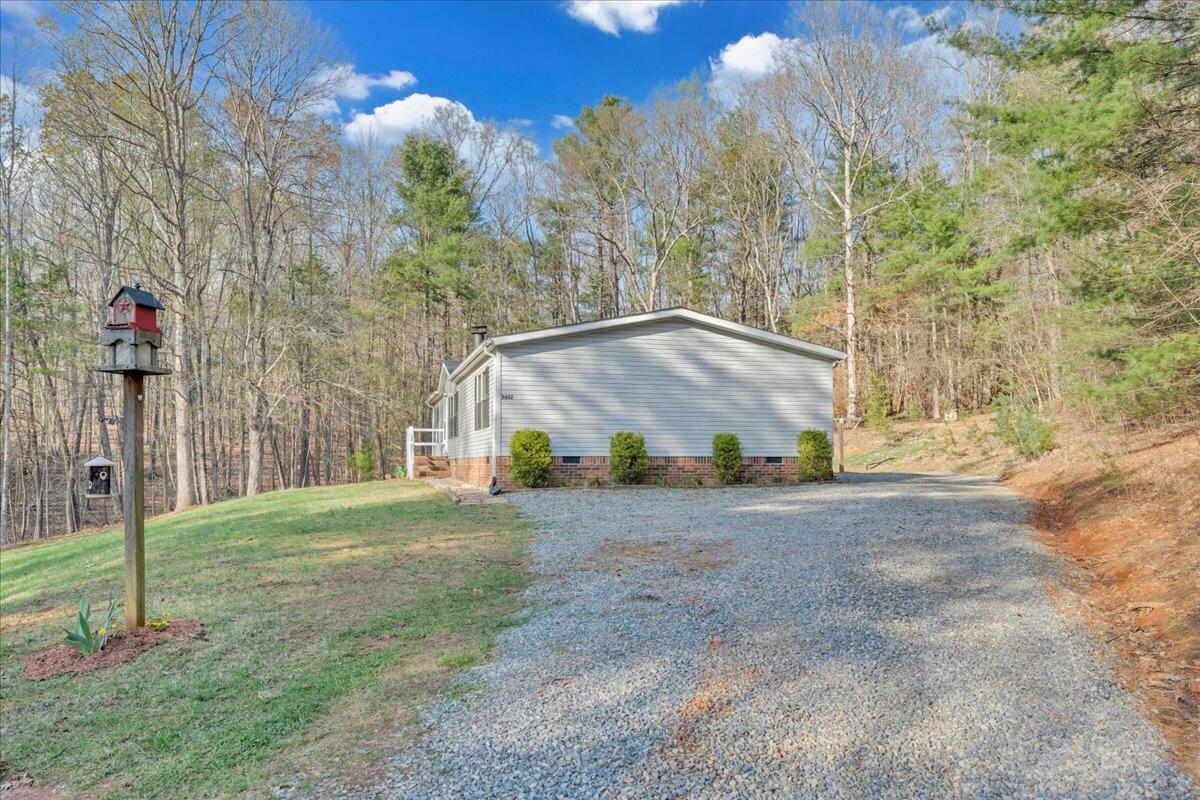 5452 Haw Patch Road Ferrum, VA 24088 - Photo 32 of 35 a white house that has a tree in front of it
