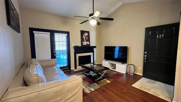 a living room with furniture fireplace and a flat screen tv