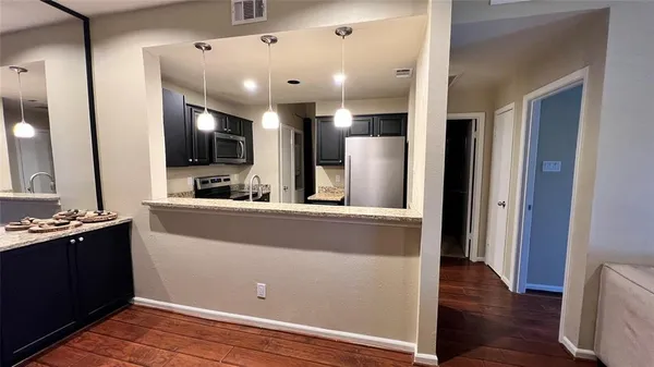 a view of kitchen with cabinets and wooden floor