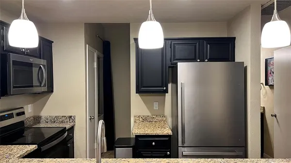 a refrigerator freezer sitting inside of a kitchen