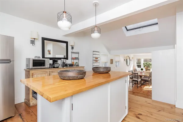 a kitchen with a counter space appliances and wooden floor
