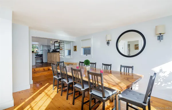 a dining room with furniture and a mirror