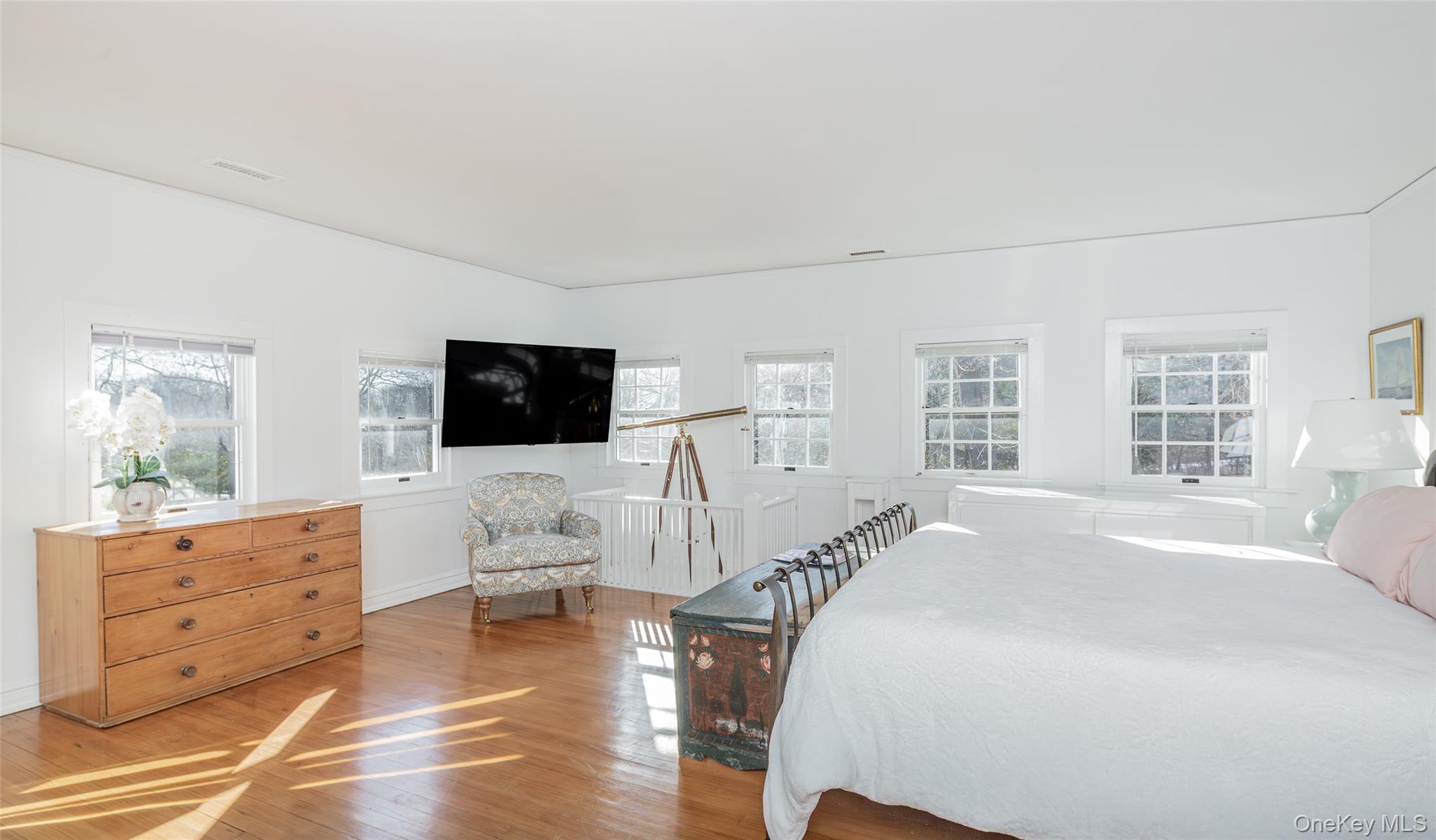 78 Mecox Road Water Mill, NY 11976 - Photo 26 of 41 a spacious bedroom with a bed and a flat screen tv