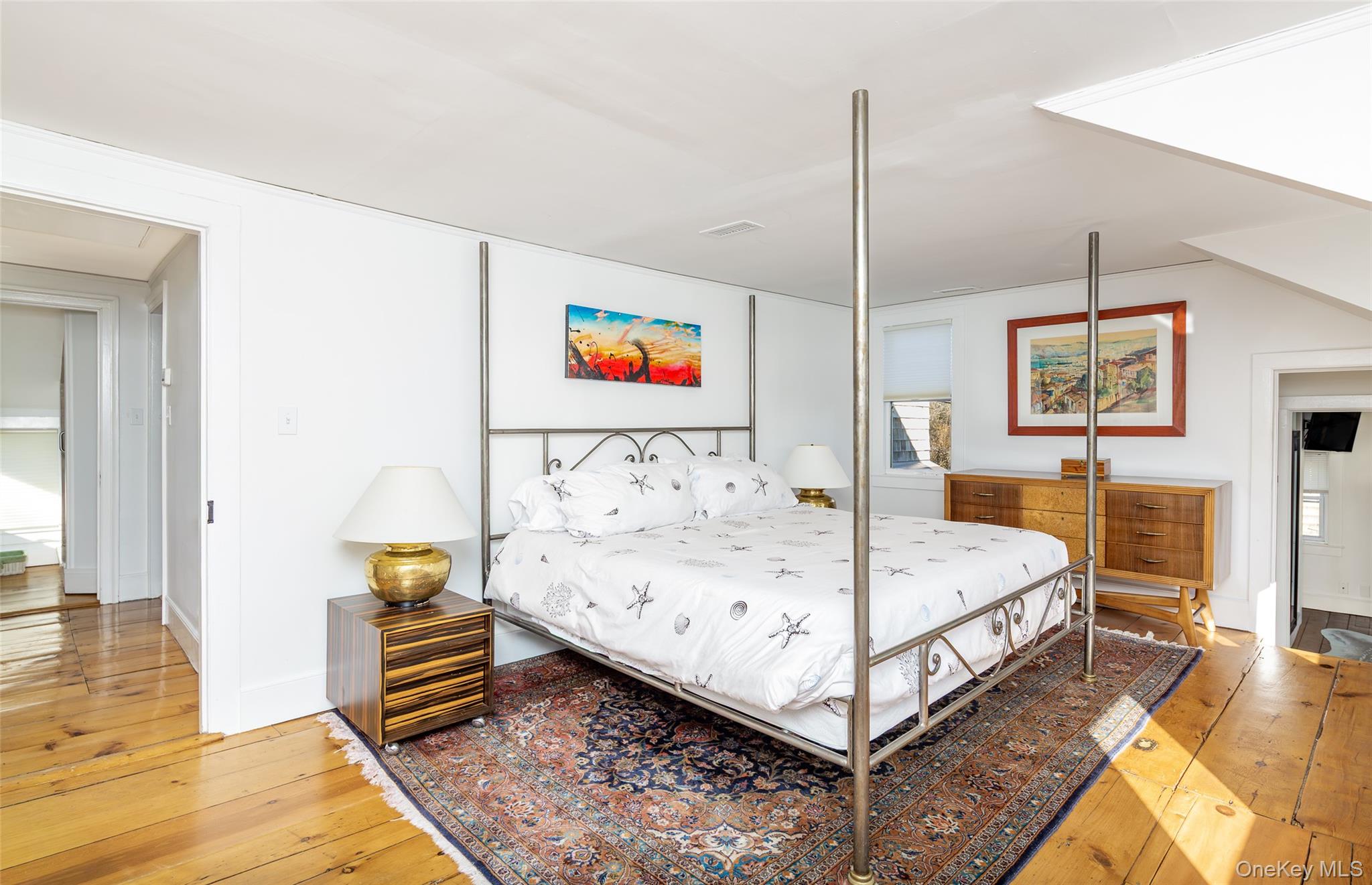 78 Mecox Road Water Mill, NY 11976 - Photo 32 of 41 a bedroom with a bed and wooden floor