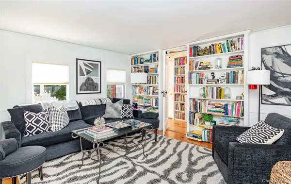 a living room with fireplace furniture and a book shelf