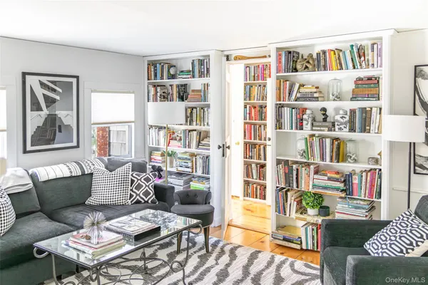 a living room with furniture and a book shelf